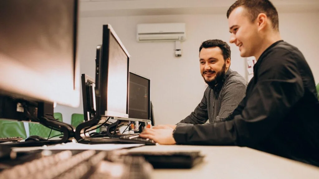 A bcom ICT technician working on a business computer at a client site on the Gold Coast